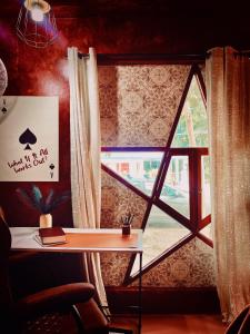 a window in a room with a desk and a table at Alter Space Workspace and CoLiving in General Luna