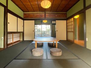 a room with a table and two stools at 蒼々さぬき志度 SOUSOU Sanuki Shido in Sanuki
