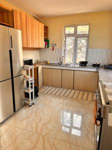 an empty kitchen with a refrigerator and a window at EcoDream Lodge in Port Mathurin +6 photos
