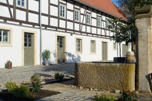 a white building with a black and white building at Rittergut Rottewitz in Meißen
