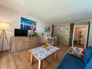 a living room with a tv and a table at Łagów apartament z plażą i pomostem in Łagów