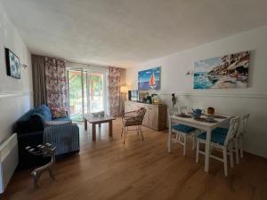 a living room with a table and a dining room at Łagów apartament z plażą i pomostem in Łagów