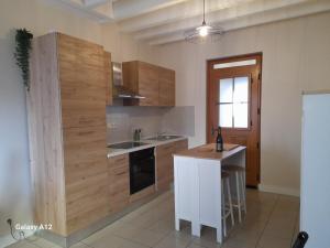 a kitchen with wooden cabinets and a counter top at Maison centre ville Bourgueil in Bourgueil