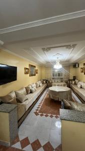 a large living room with couches and a tv at Nador in Nador
