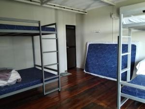 a room with two bunk beds and a wooden floor at MGS viewdeck resort in Samal