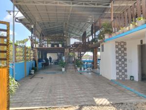a large building with a wooden ceiling and a patio at MGS viewdeck resort in Samal