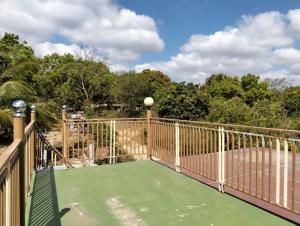 a balcony with a green floor and a fence at MGS viewdeck resort in Samal