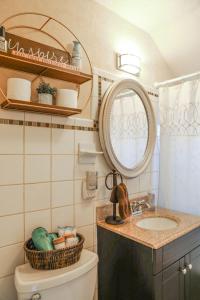 a bathroom with a sink and a mirror and a toilet at Gatekeeper Cottage Views, Fireplace, EV in Afton +55 photos
