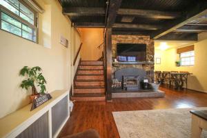 a living room with a staircase and a fireplace at Gatekeeper Cottage Views, Fireplace, EV in Afton