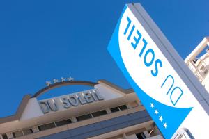 a building with a uvu sign in front of it at Hotel Du Soleil in Rimini