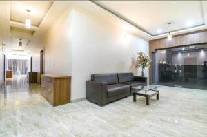 a living room with a couch and a table at Hotel Holiday Palace in Sibsāgar