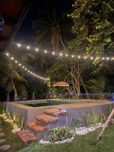 a swimming pool with lights and stairs in a yard at Casita Agnes Private Resort in Boac