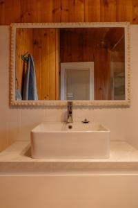 a white sink in a bathroom with a mirror at Sampsons Shack in Vivonne Bay +24 photos