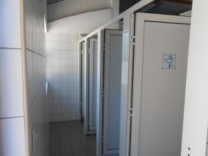 a hallway of a bathroom with two open doors at Camping de Tournus - Drole de cabane in Tournus