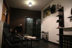 a bathroom with a shower and a black wall at La Crème in Ostend +11 photos