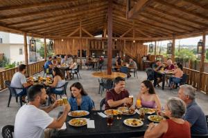 a group of people eating at a restaurant at HostaSuites Mijinn in Playas