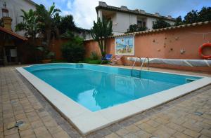 a swimming pool in a yard next to a house at Villa Salvatore in San Leone