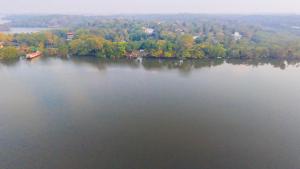 an aerial view of a large lake with trees at Pearl Bolgoda in Piliyandala