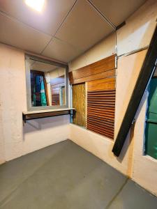 an empty room with two windows in a building at Pearl Bolgoda in Piliyandala +20 photos