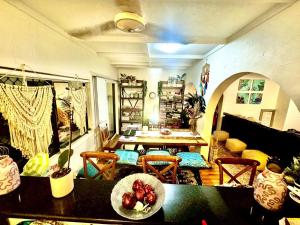 a living room with a table and a dining room at Backpacker Bunks and Queen Pool Clifton Beach in Clifton Beach
