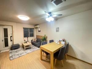 a living room with a table and a couch at Yoshimi Stay Kawaguchi in Kawaguchi +15 photos
