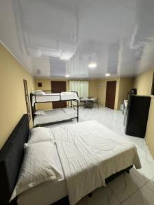 a hospital room with two beds and a tv at Alojamiento Golfito in Golfito
