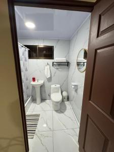 a bathroom with a toilet and a sink at Alojamiento Golfito in Golfito