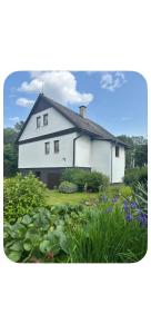 a white house with a garden in front of it at Jarmila in Tachov