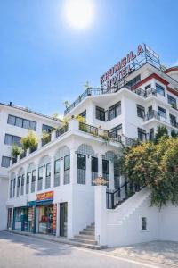 a white building with a staircase in front of it at Hotel Khumbila in Kathmandu