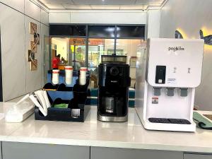 a coffee machine sitting on a counter in a store at City Center Hotel Manila Near Airport and PITX Casinos Exhibition Center in Manila