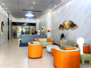 an office lobby with orange and white furniture at City Center Hotel Manila Near Airport and PITX Casinos Exhibition Center in Manila