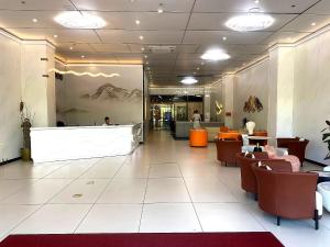 a lobby of a restaurant with tables and chairs at City Center Hotel Manila Near Airport and PITX Casinos Exhibition Center in Manila