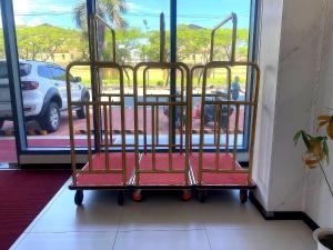 a trolley with red seats in front of a window at City Center Hotel Manila Near Airport and PITX Casinos Exhibition Center in Manila +9 photos