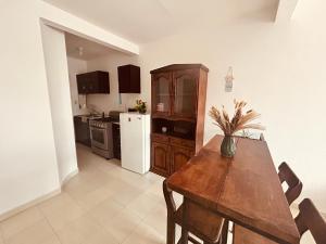 a kitchen with a wooden table and a dining room at Arroyito Depto Pequeño in Tuxtla Gutiérrez