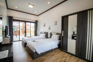 a hotel room with two beds and a television at laboon pool villa Pranburi in Ban Nong Ban Kao +38 photos