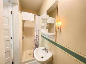 a small bathroom with a sink and a mirror at Strathaird Bed and Breakfast in Niagara Falls +33 photos