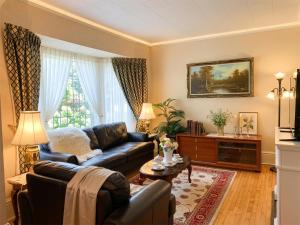 a living room with a couch and a table at Strathaird Bed and Breakfast in Niagara Falls