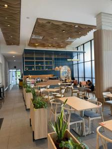 a restaurant with tables and chairs and windows at The Aerie in Kuala Lumpur