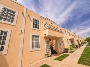 a large apartment building with a sidewalk in front of it at Private Apartment in Prague Poniente Area in Hermosillo