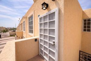 a white door on the side of a building at Private Apartment in Prague Poniente Area in Hermosillo +2 photos