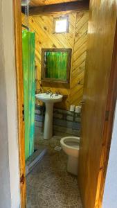 a bathroom with a toilet and a sink at La cabaña de Noe in San Clemente del Tuyú +1 photo