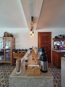a kitchen with a counter with a coffee maker on it at Casa Ilhéus Pousada in Ilhéus