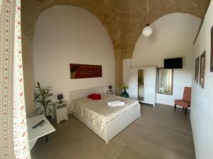 a bedroom with a bed and a table and a tv at B&B "Sara" in Gemini