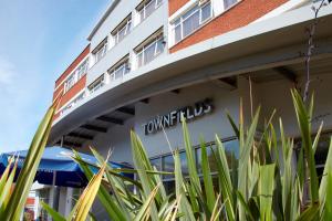 a view of the front of a hotel with plants at Best Western Manchester Altrincham Cresta Court Hotel in Altrincham