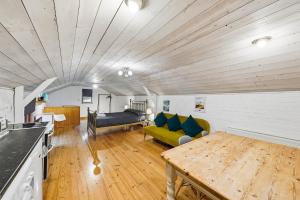 a living room with a couch and a table at Lee Valley Lodge Upper Floor in Cheshunt