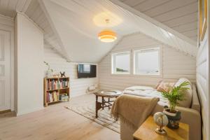 a living room with a couch and a table at The Nordic Loft in Bergen