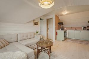 a living room with a couch and a table at The Nordic Loft in Bergen