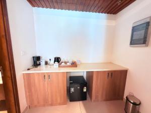 a kitchen with a counter with a trash can at KTDC Malabar Courtyard in Mulappilangād