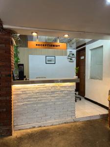a reception area of a restaurant with a brick wall at Pagupon Camp Syariah in Batu +39 photos