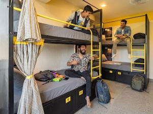 a group of men sitting on bunk beds in a room at The Hosteller Goa, Anjuna in Arpora +21 photos